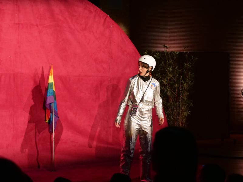 An astronaut with a rainbow flag