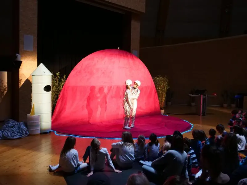 A pink planet with two astronauts