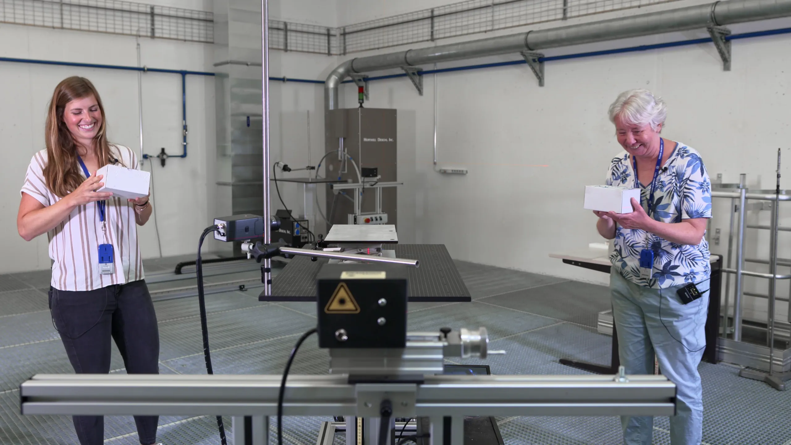 CERN scientists Pippa Wells and Sabrina Schadegg give the primary schools challenge a go